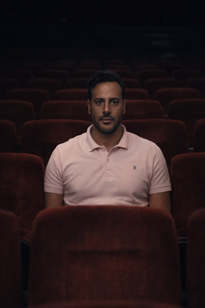 Iliya Keyvan seated alone in a cinema
